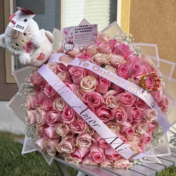 Large pink rose bouquet with a Hello Kitty plush and ribbons