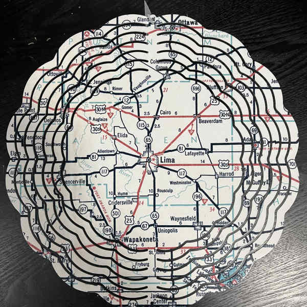 Round map-cutout decorative piece with layered black rings