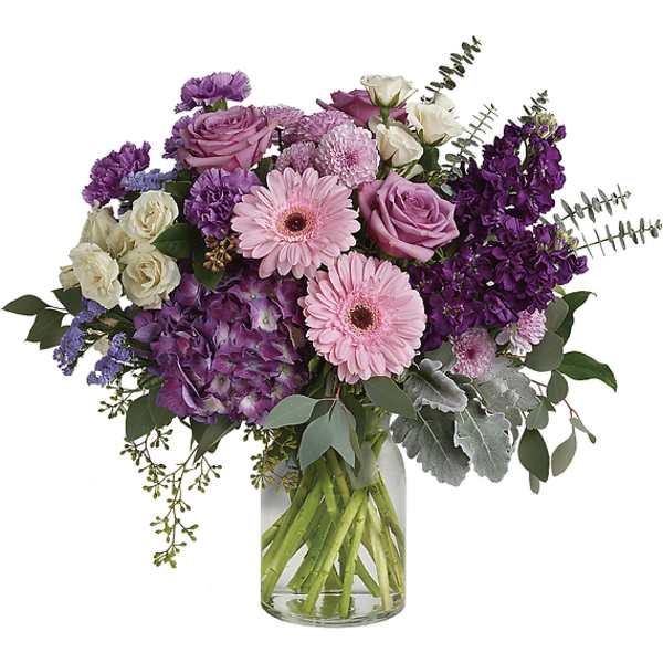 Bouquet of pink, purple, and white flowers in a clear glass vase