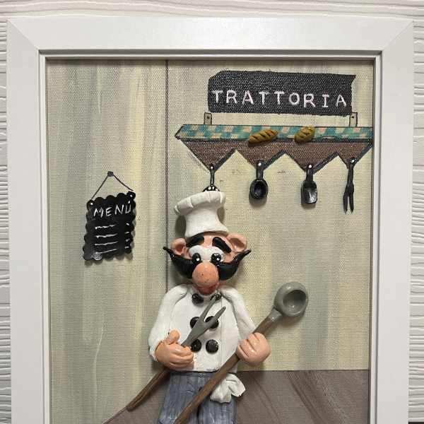 Framed wall art of a cartoon chef in front of a trattoria sign