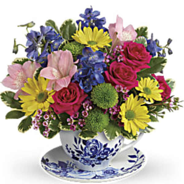 Colorful bouquet in a blue-and-white teacup and saucer