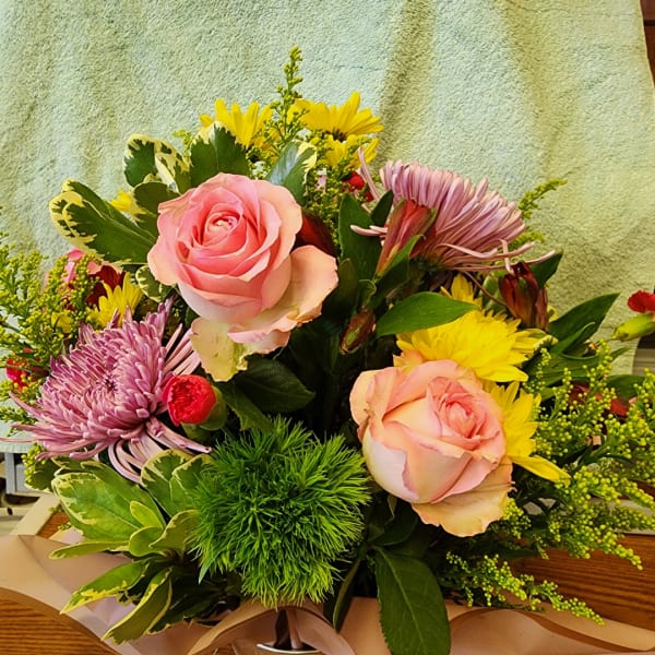Mixed bouquet with pink roses, yellow daisies, and purple mums
