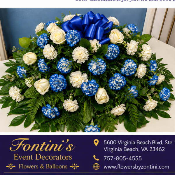 Blue and white floral arrangement with a large blue bow