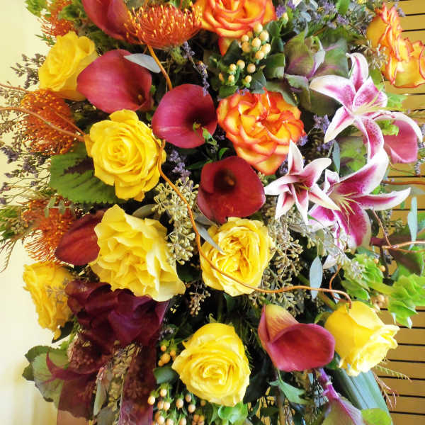 Large bouquet with yellow roses, burgundy calla lilies, and pink lilies
