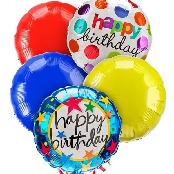 Cluster of colorful birthday balloons with printed messages