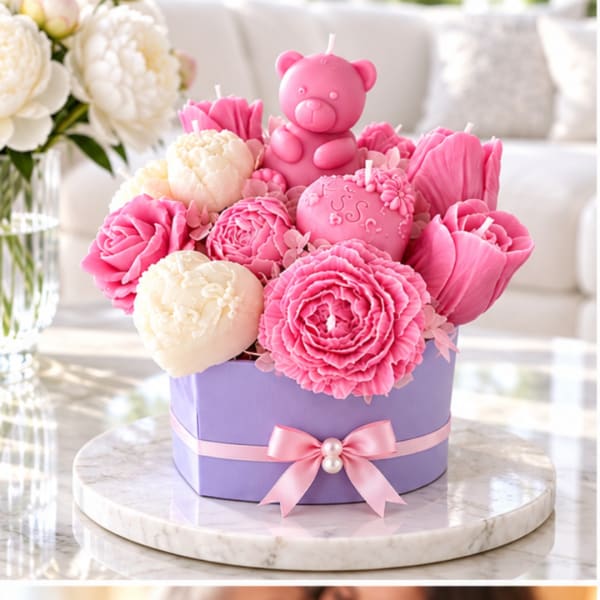 Pink and cream flower-shaped candles in a lavender gift box with a teddy bear candle