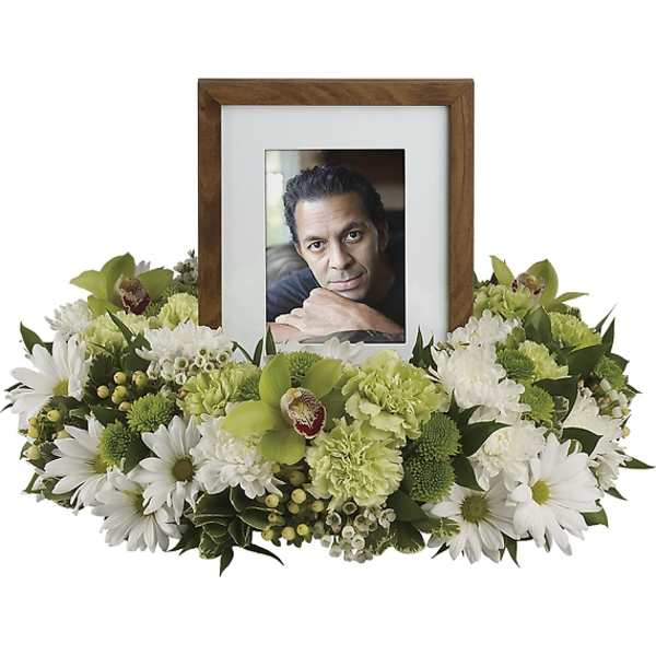 Framed photo surrounded by white and green flowers