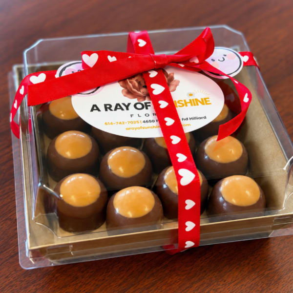 Box of chocolates tied with a red heart ribbon