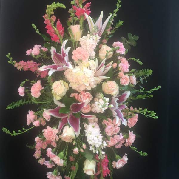 Tall pink and white floral standing spray with lilies and roses