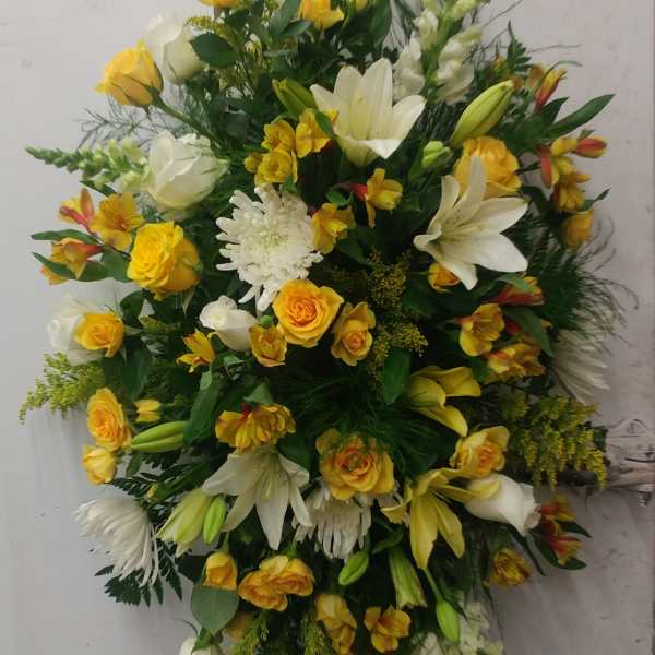 Large yellow and white floral spray with lilies and roses