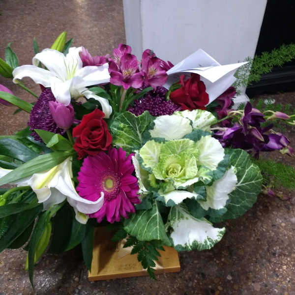 Mixed bouquet with lilies, roses, gerbera daisies, and purple orchids