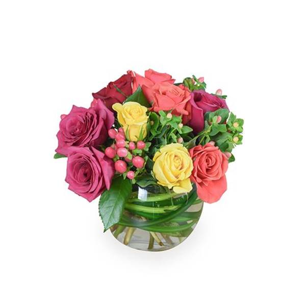 Mixed roses in a round glass vase