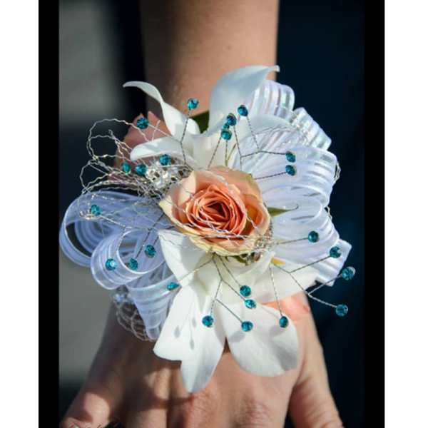 White and peach wrist corsage with blue bead accents
