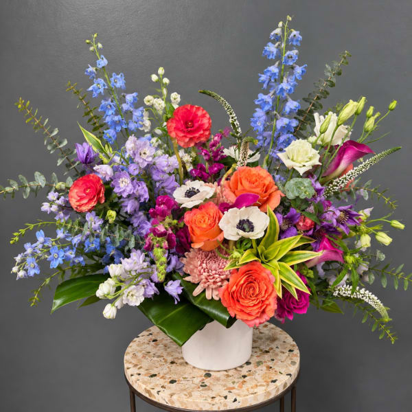 Colorful mixed flower arrangement in a white vase