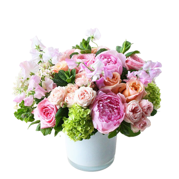 Pink and peach flower arrangement in a white vase