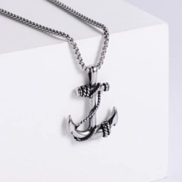 Silver anchor pendant necklace on a white box