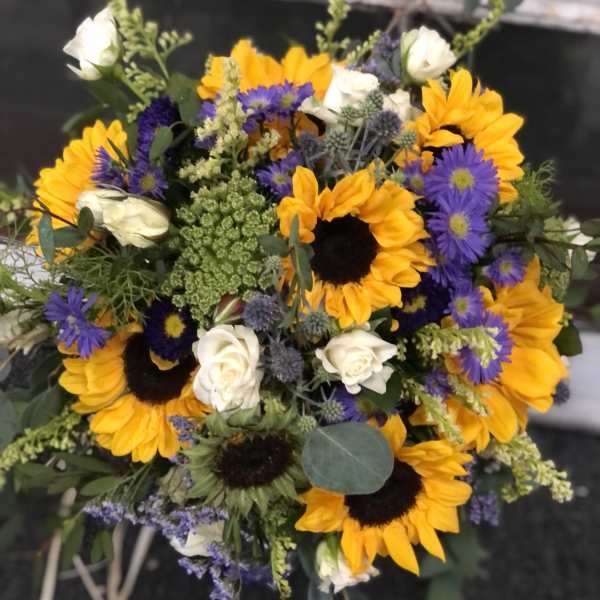 Bouquet of sunflowers, white roses, and purple asters