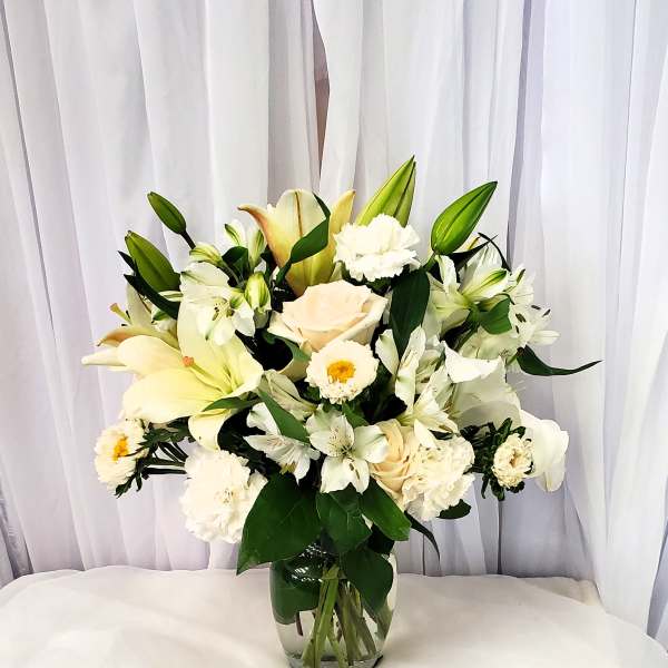 White floral arrangement in a clear glass vase