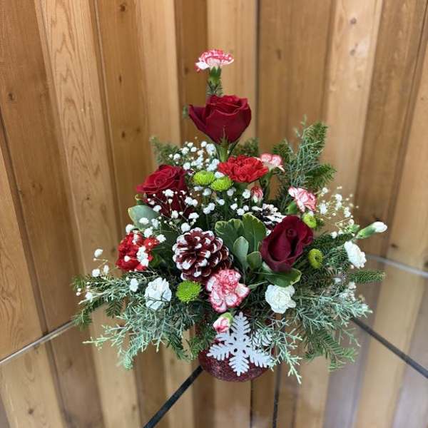 Red roses and carnations in a festive holiday arrangement