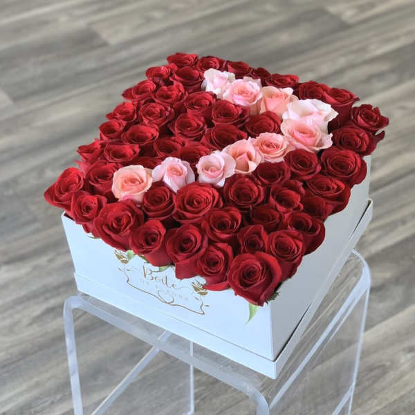 Heart-shaped box filled with red and pink roses