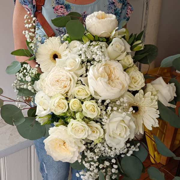 Large bouquet of white roses and gerbera daisies with eucalyptus