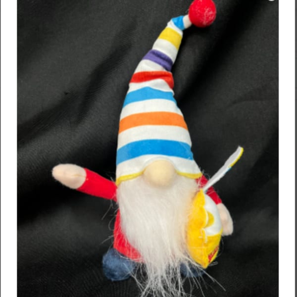 Small striped gnome figurine with a red hat and white beard