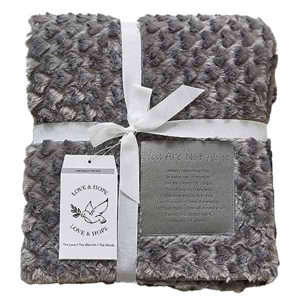 Gray plush blanket tied with a white ribbon and sympathy tags