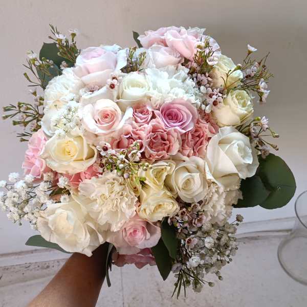 Bouquet of pink and white roses with small filler flowers