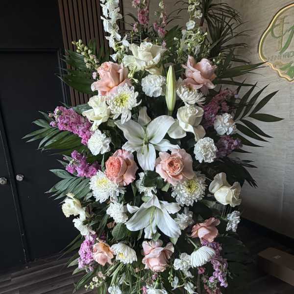 Large standing floral spray with white lilies, pink roses, and white chrysanthemums
