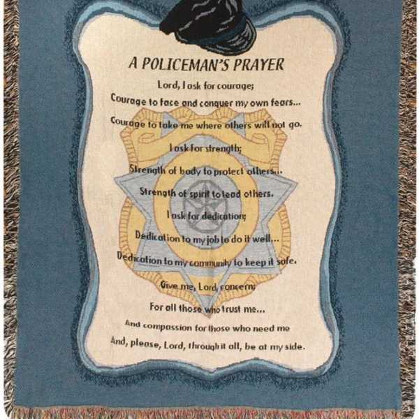 A woven blanket with a police badge design and prayer text