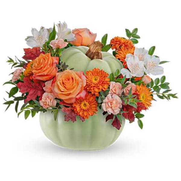Fall floral arrangement in a pale green pumpkin vase