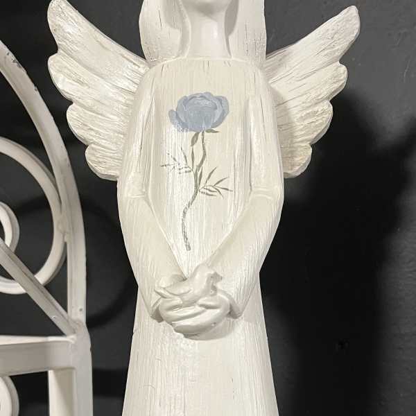 White angel figurine with blue floral painting and wings