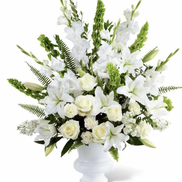 White lilies and roses arranged in a white vase