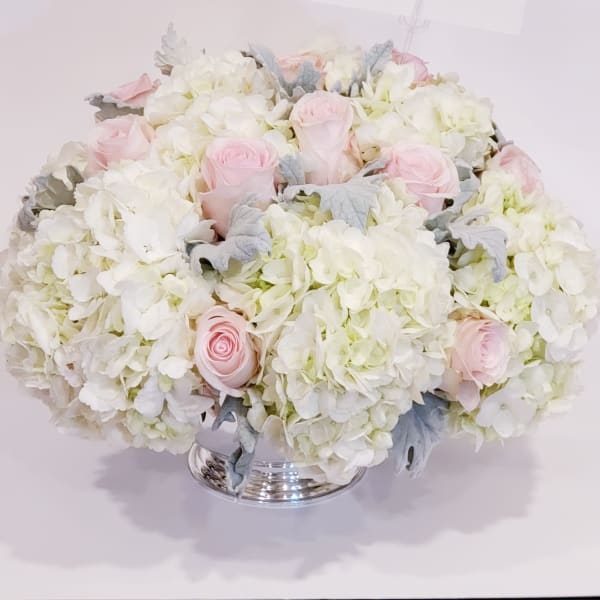 Pink roses and white hydrangeas in a silver vase