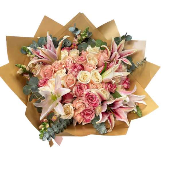 Bouquet of pink and cream roses with lilies wrapped in brown paper