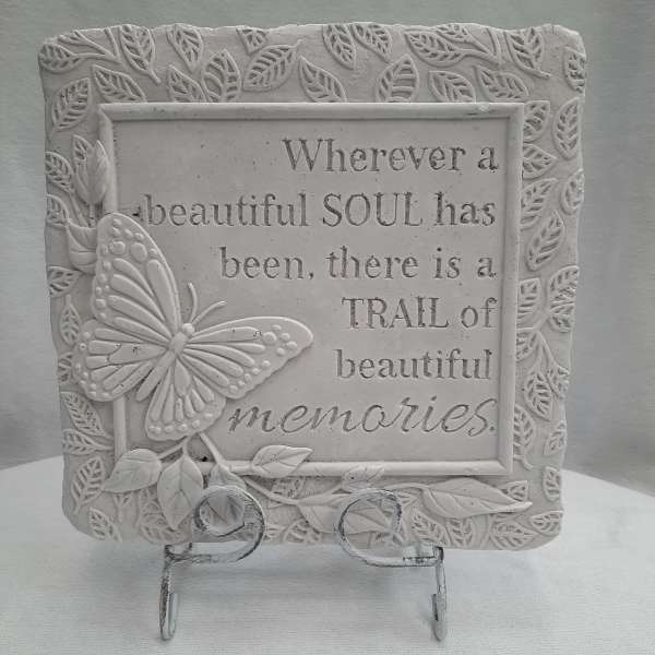 Decorative plaque with a butterfly and memorial quote on a stand