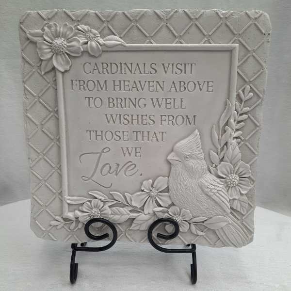Decorative plaque with a cardinal and floral relief around a sympathy message