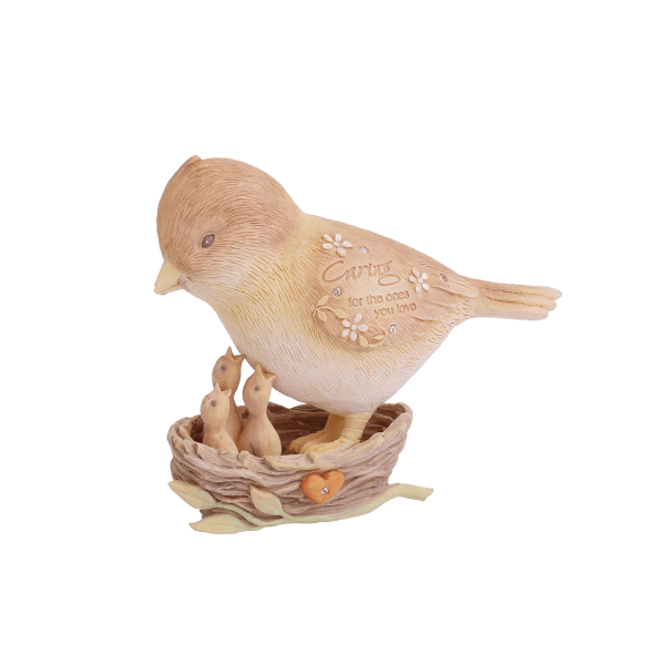 Decorative bird figurine in a nest with three chicks