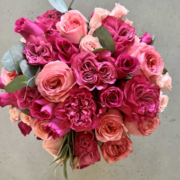Bouquet of pink and peach roses with eucalyptus leaves