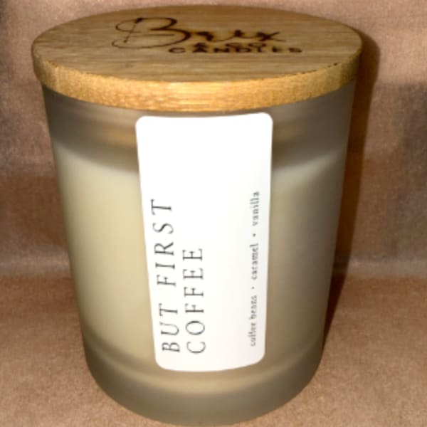 Frosted glass candle jar with a wooden lid and label