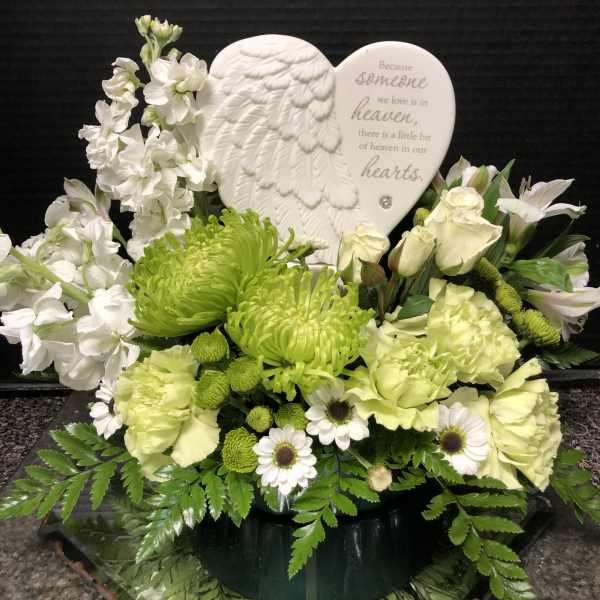 White and green sympathy arrangement with a heart memorial plaque