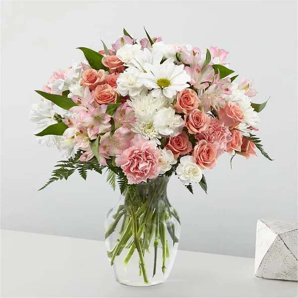 Pink and white mixed bouquet in a clear glass vase