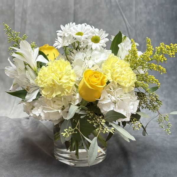 Yellow and white bouquet in a clear glass vase
