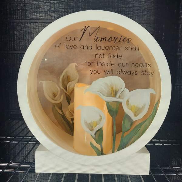 Decorative memorial plate with white calla lilies and a remembrance message