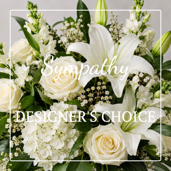 White roses and lilies in a sympathy arrangement with overlaid text