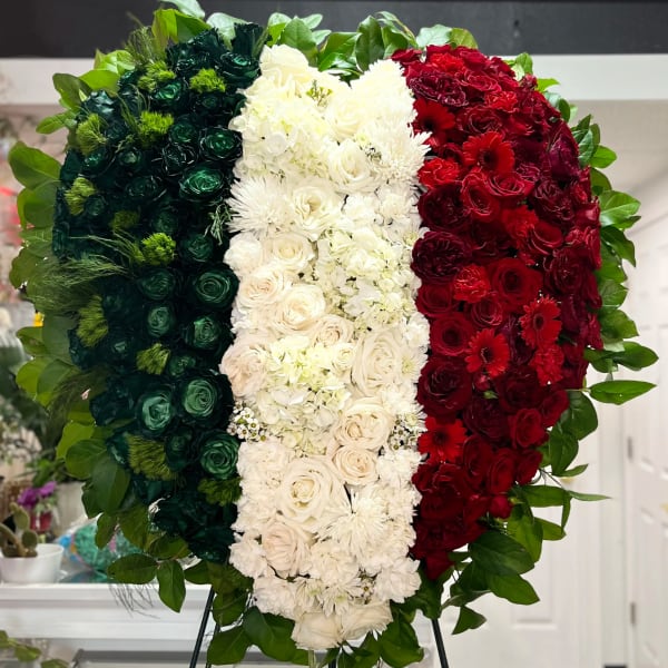 Large tricolor floral standing arrangement in green, white, and red