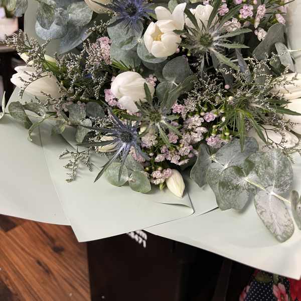 Bouquet of white tulips and pale pink flowers with eucalyptus