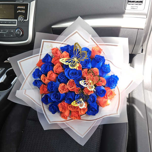 Bouquet of blue and orange roses with butterfly decorations