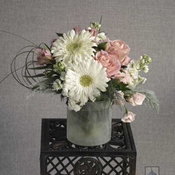 Pink roses and white daisies in a frosted vase