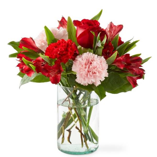 Red and pink mixed bouquet in a clear glass vase